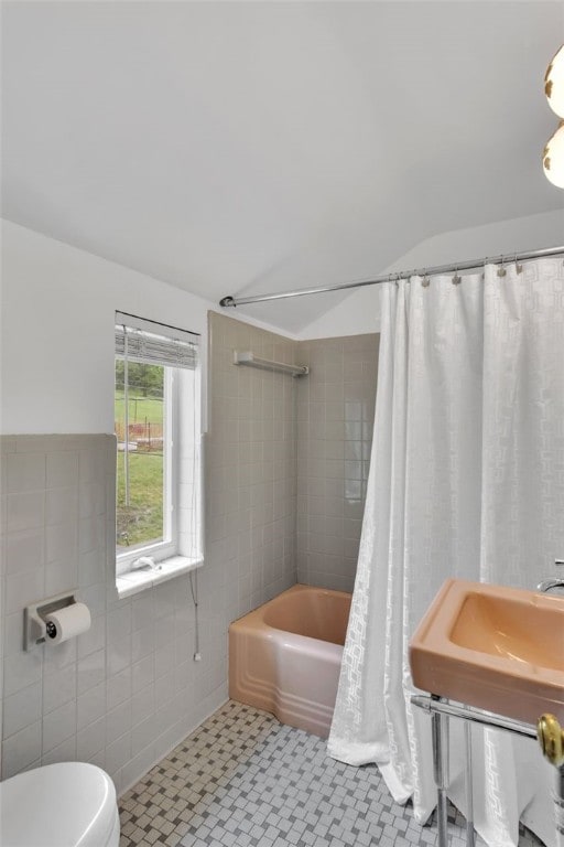 5352 Highgrove Rd, Whitehall, PA 15236 - full bath with shower / bath combo with shower curtain, toilet, vaulted ceiling, and tile walls