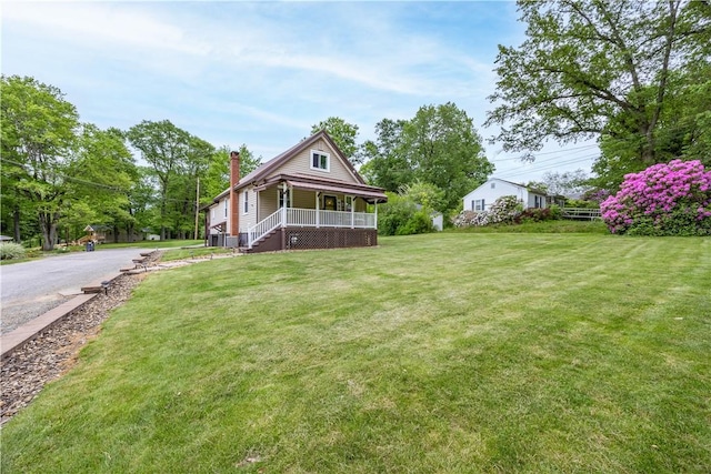 1248 Hyde Park Rd, Allegheny Twp Wml, PA 15656 - view of front facade featuring a porch, a chimney, and a front lawn