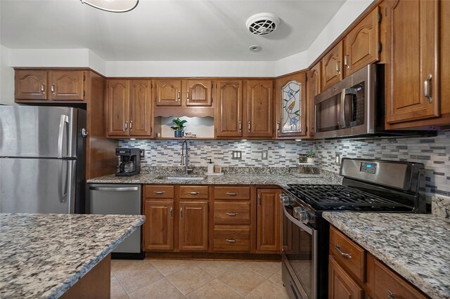 1426 Raven Dr, Pittsburgh, PA 15243 - kitchen with stainless steel appliances, a sink, and light stone countertops