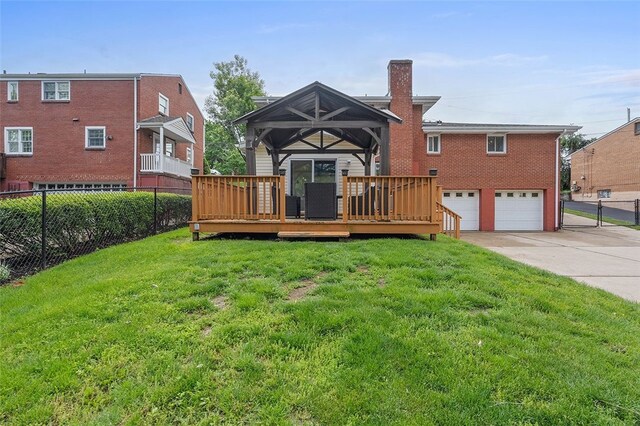 1426 Raven Dr, Pittsburgh, PA 15243 - back of house featuring concrete driveway, a chimney, an attached garage, a wooden deck, and brick siding