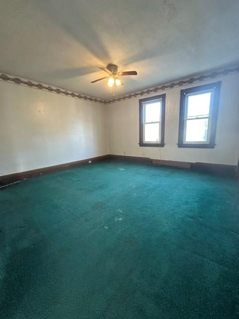213 Indiana Ave, Avonmore, PA 15618 - empty room featuring ceiling fan, baseboards, and dark carpet