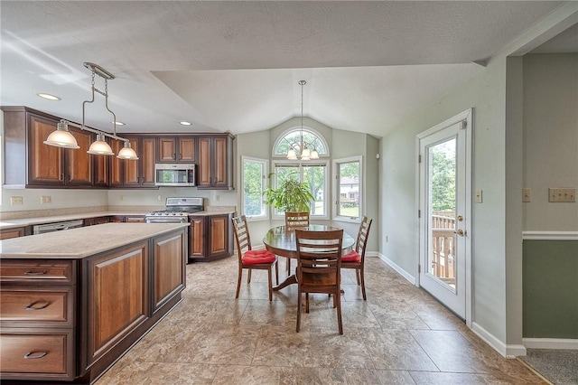 3318 Carriage Cir, Murrysville, PA 15632 - kitchen featuring stainless steel appliances, plenty of natural light, baseboards, lofted ceiling, and pendant lighting