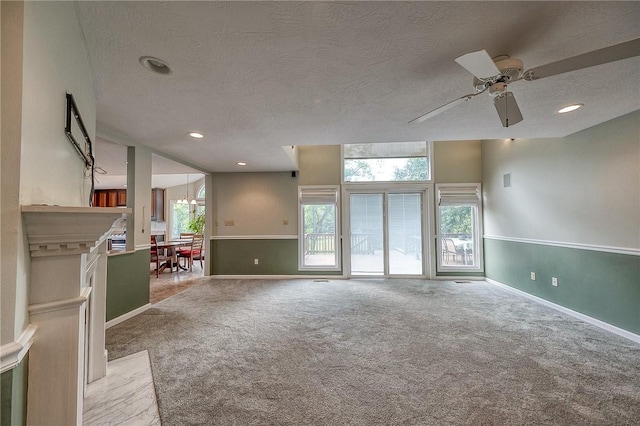 3318 Carriage Cir, Murrysville, PA 15632 - unfurnished living room featuring carpet, a textured ceiling, baseboards, a ceiling fan, and recessed lighting