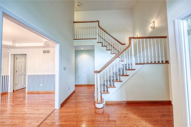 3318 Carriage Cir, Murrysville, PA 15632 - stairway featuring wood finished floors, baseboards, and a towering ceiling