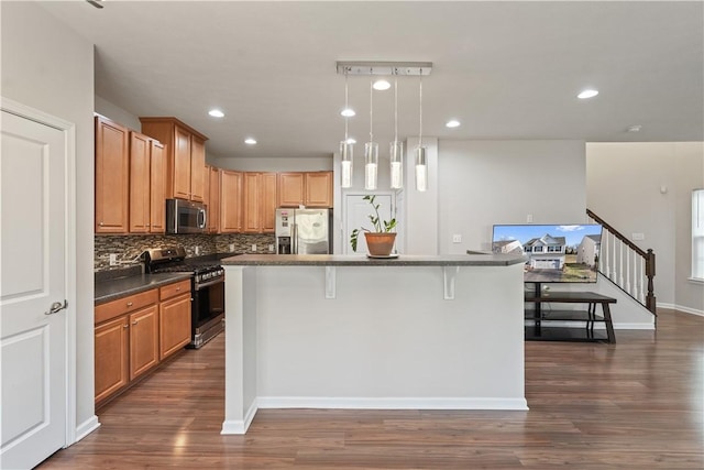 6202 Lenox Ln, South Fayette, PA 15057 - kitchen with stainless steel appliances, dark countertops, dark wood-type flooring, backsplash, and recessed lighting