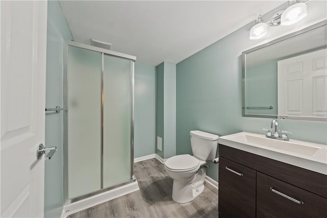 6202 Lenox Ln, South Fayette, PA 15057 - bathroom featuring vanity, a stall shower, wood finished floors, toilet, and baseboards