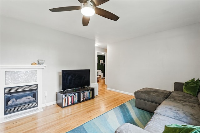 244 Burch Dr, Coraopolis, PA 15108 - living area with wood finished floors, a fireplace, ceiling fan, and baseboards