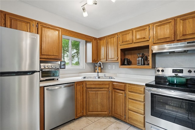 244 Burch Dr, Coraopolis, PA 15108 - kitchen featuring stainless steel appliances, under cabinet range hood, a sink, light countertops, and light tile patterned flooring