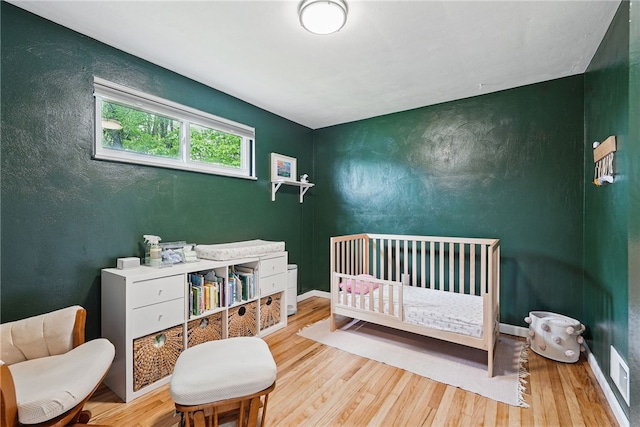 244 Burch Dr, Coraopolis, PA 15108 - bedroom with wood finished floors, a nursery area, and baseboards