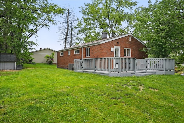 244 Burch Dr, Coraopolis, PA 15108 - rear view of house featuring brick siding, central air condition unit, a wooden deck, and a lawn