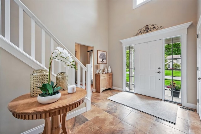 2104 Pierce Bluffs Dr, Hermitage, PA 16148 - entryway with healthy amount of natural light, stairs, a towering ceiling, and baseboards