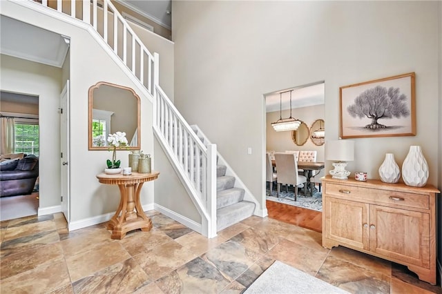 2104 Pierce Bluffs Dr, Hermitage, PA 16148 - staircase featuring a towering ceiling, baseboards, stone finish floors, and crown molding
