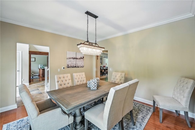 2104 Pierce Bluffs Dr, Hermitage, PA 16148 - dining space featuring crown molding, baseboards, wood finished floors, and a chandelier