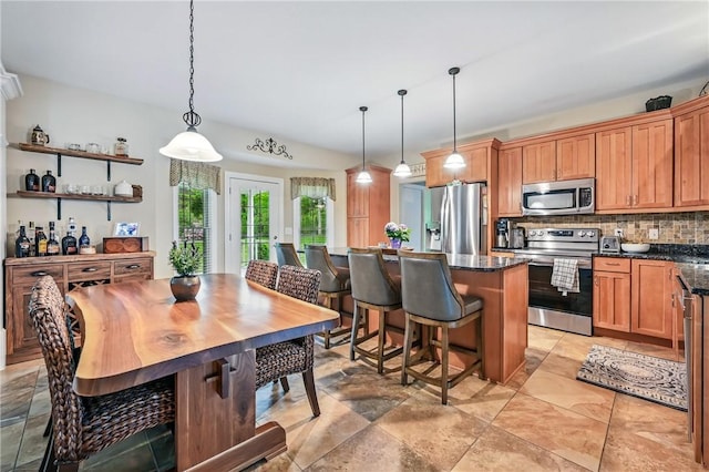 2104 Pierce Bluffs Dr, Hermitage, PA 16148 - kitchen with stainless steel appliances, tasteful backsplash, pendant lighting, a kitchen island, and a kitchen breakfast bar