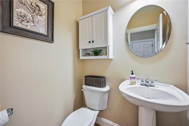 2104 Pierce Bluffs Dr, Hermitage, PA 16148 - half bathroom featuring toilet, baseboards, and a sink