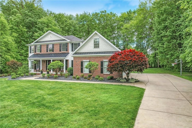 2104 Pierce Bluffs Dr, Hermitage, PA 16148 - view of front of property with a standing seam roof, a front lawn, brick siding, and covered porch