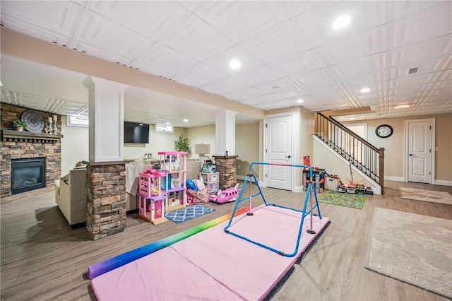 2104 Pierce Bluffs Dr, Hermitage, PA 16148 - playroom featuring a stone fireplace, wood finished floors, recessed lighting, and baseboards