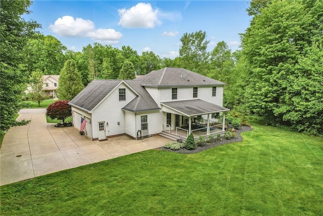 2104 Pierce Bluffs Dr, Hermitage, PA 16148 - back of house with a yard, a garage, roof with shingles, and a patio area