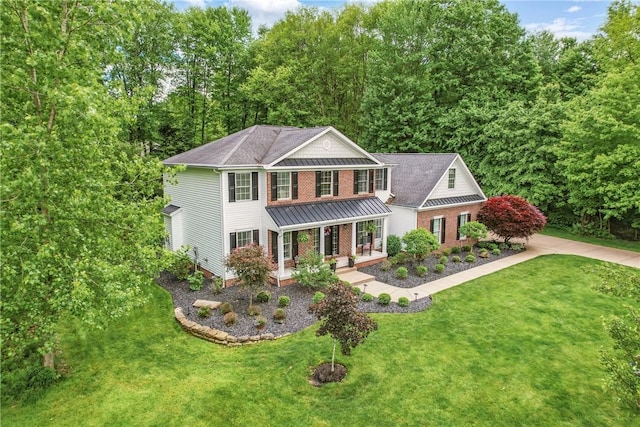 2104 Pierce Bluffs Dr, Hermitage, PA 16148 - view of front of property featuring covered porch, a standing seam roof, a front lawn, and brick siding