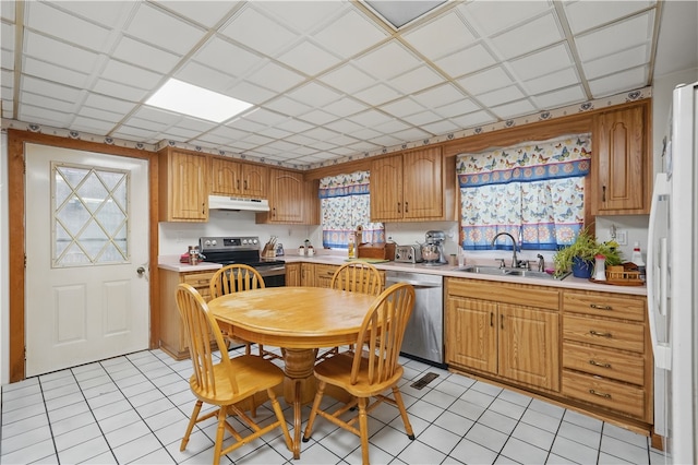 310 Main St, Belle Vernon Fay, PA 15012 - kitchen featuring stainless steel appliances, a sink, under cabinet range hood, light countertops, and light tile patterned floors