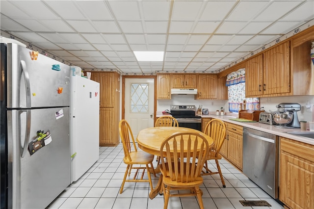 310 Main St, Belle Vernon Fay, PA 15012 - kitchen with stainless steel appliances, under cabinet range hood, light countertops, and light tile patterned floors