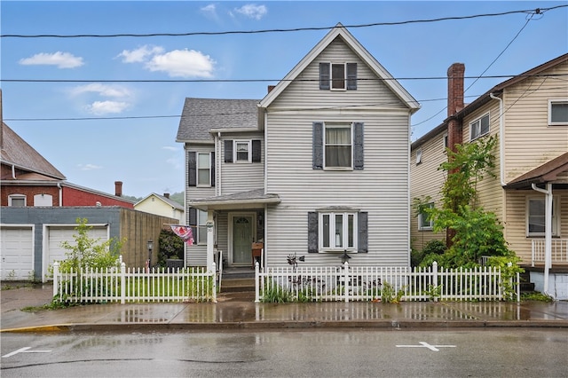 310 Main St, Belle Vernon Fay, PA 15012 - traditional home featuring roof with shingles, a fenced front yard, and a garage