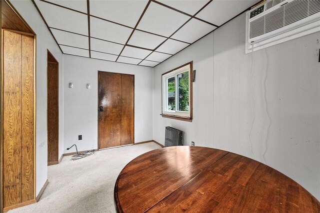 446 S Dallas Ave, Point Breeze, PA 15208 - unfurnished dining area featuring radiator, carpet flooring, a paneled ceiling, an AC wall unit, and baseboards