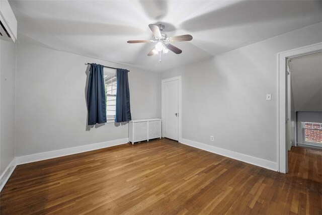 446 S Dallas Ave, Point Breeze, PA 15208 - unfurnished bedroom featuring wood finished floors, baseboards, and a ceiling fan