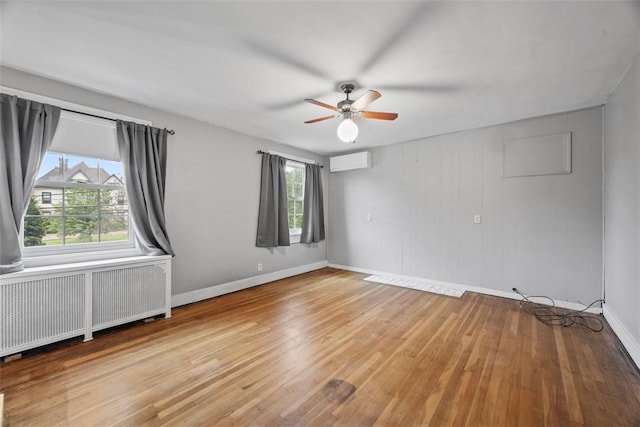 446 S Dallas Ave, Point Breeze, PA 15208 - spare room featuring radiator, a wall mounted air conditioner, plenty of natural light, and ceiling fan