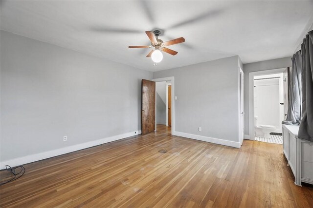 446 S Dallas Ave, Point Breeze, PA 15208 - unfurnished bedroom with baseboards, light wood finished floors, ensuite bath, and a ceiling fan