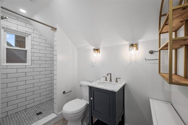 446 S Dallas Ave, Point Breeze, PA 15208 - bathroom featuring a tile shower, toilet, vanity, vaulted ceiling, and recessed lighting