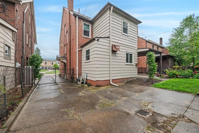 446 S Dallas Ave, Point Breeze, PA 15208 - view of side of property featuring a gate, central air condition unit, and driveway