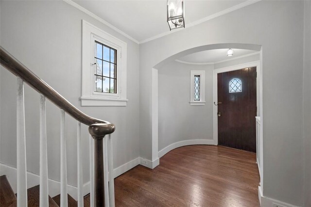 446 S Dallas Ave, Point Breeze, PA 15208 - foyer entrance featuring arched walkways, crown molding, wood finished floors, baseboards, and stairs