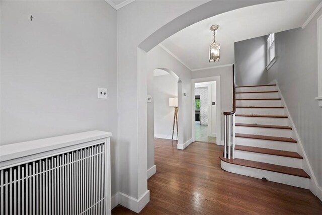 446 S Dallas Ave, Point Breeze, PA 15208 - entryway featuring arched walkways, ornamental molding, wood finished floors, baseboards, and stairway