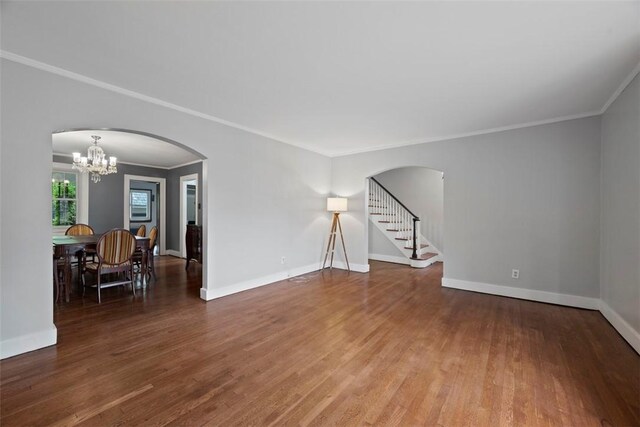 446 S Dallas Ave, Point Breeze, PA 15208 - empty room with a chandelier, wood finished floors, arched walkways, ornamental molding, and baseboards