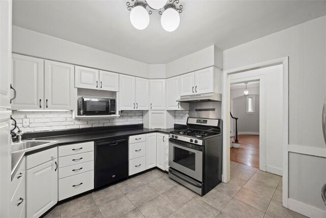 446 S Dallas Ave, Point Breeze, PA 15208 - kitchen with stainless steel range with gas stovetop, dishwasher, decorative backsplash, light tile patterned floors, and dark countertops