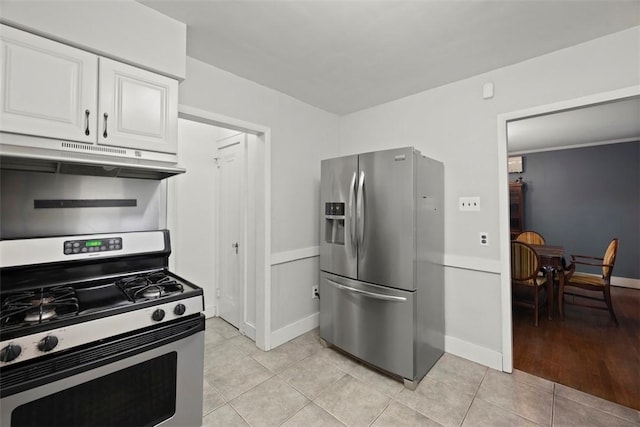 446 S Dallas Ave, Point Breeze, PA 15208 - kitchen featuring stainless steel appliances, under cabinet range hood, white cabinets, light tile patterned floors, and baseboards