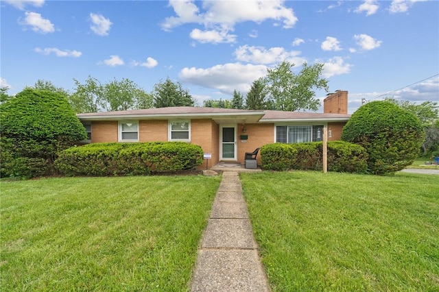954 Illinois Ave, Braddock Hills, PA 15221 - ranch-style house with a chimney, a front yard, and brick siding