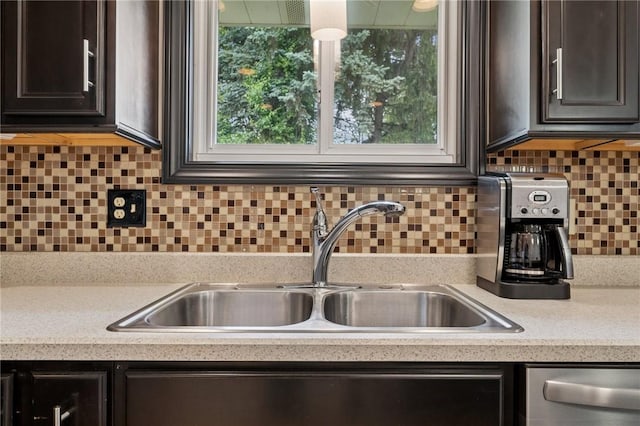 954 Illinois Ave, Braddock Hills, PA 15221 - kitchen with a sink, stainless steel dishwasher, light countertops, dark brown cabinets, and decorative backsplash