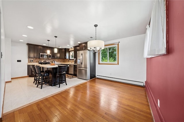 954 Illinois Ave, Braddock Hills, PA 15221 - dining room with a baseboard heating unit, a chandelier, light wood finished floors, recessed lighting, and baseboards