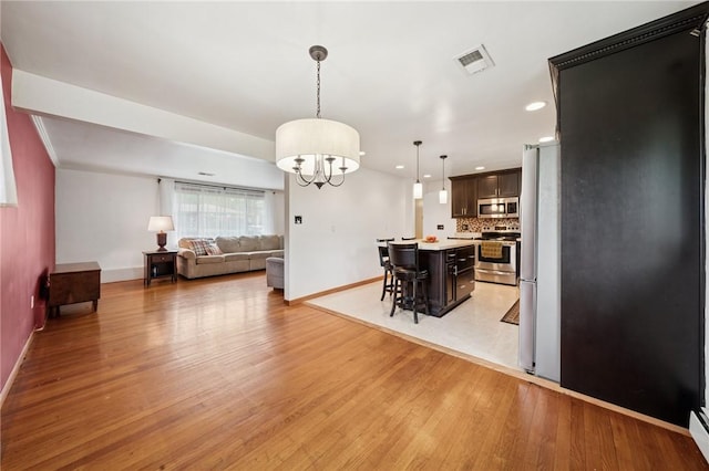 954 Illinois Ave, Braddock Hills, PA 15221 - dining area featuring baseboards, light wood-style flooring, a chandelier, and recessed lighting