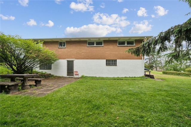 954 Illinois Ave, Braddock Hills, PA 15221 - rear view of house with a yard and brick siding