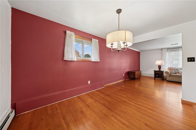 954 Illinois Ave, Braddock Hills, PA 15221 - empty room featuring a baseboard radiator, a chandelier, wood finished floors, and baseboards