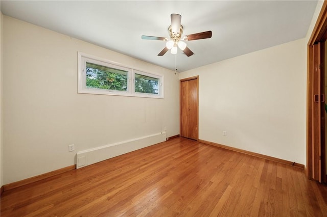 954 Illinois Ave, Braddock Hills, PA 15221 - spare room featuring a baseboard radiator, light wood-type flooring, a ceiling fan, and baseboards