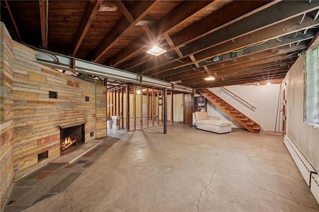 954 Illinois Ave, Braddock Hills, PA 15221 - unfinished below grade area with a baseboard heating unit, stairway, and a stone fireplace
