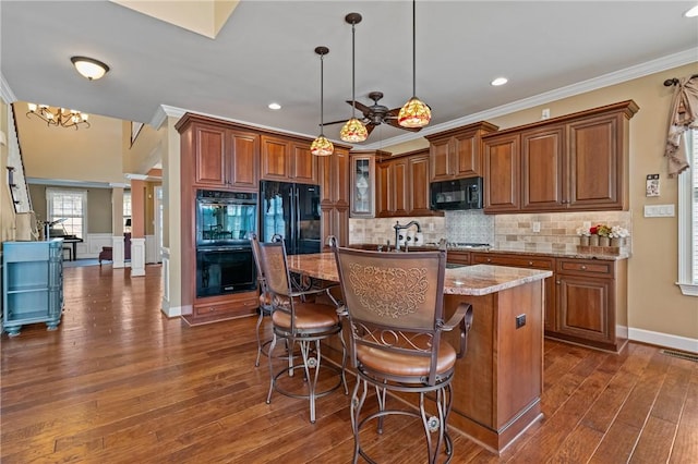 361 Patriot Ln, Economy, PA 15042 - kitchen featuring black appliances, ornamental molding, brown cabinetry, dark wood finished floors, and decorative backsplash