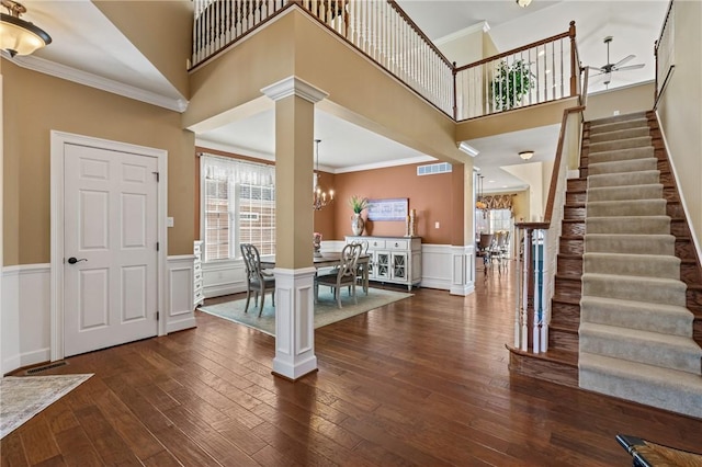 361 Patriot Ln, Economy, PA 15042 - entryway with stairway, dark wood finished floors, a wainscoted wall, ornate columns, and crown molding