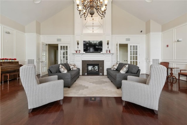 361 Patriot Ln, Economy, PA 15042 - living area with french doors, a decorative wall, high vaulted ceiling, a chandelier, and wood finished floors