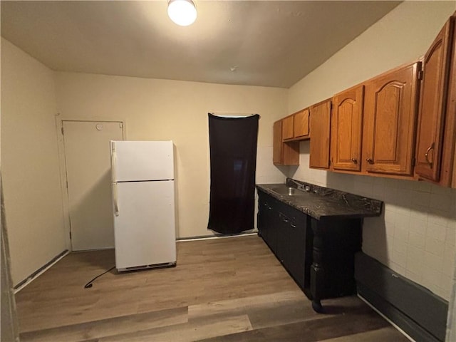 7707-7708-7710 Forest Way, Homewood-Brushton, PA 15208 - kitchen with freestanding refrigerator, light wood-style flooring, brown cabinets, and dark countertops
