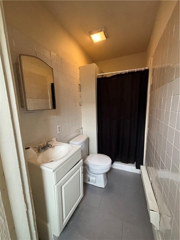 7707-7708-7710 Forest Way, Homewood-Brushton, PA 15208 - full bath featuring vanity, toilet, a shower stall, and tile walls